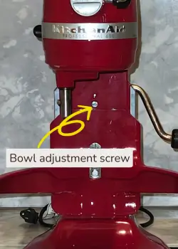 Image showing a red bowl-lift KitchenAid mixer troubleshooting of bowl adjustment screw.