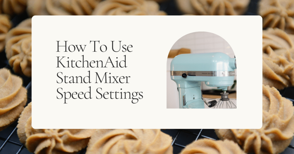 a closeup of the speed control system of a blue KitchenAid stand mixer with cookies in the background