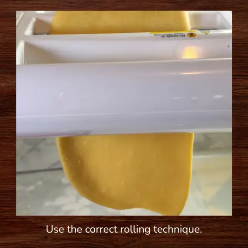 Pasta dough feeding smoothly through a pasta roller at the correct thickness using proper rolling technique for even, wrinkle-free pasta sheets.