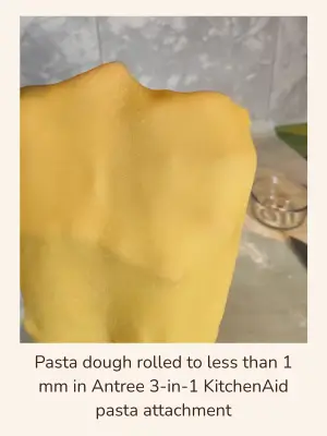 Thin sheet of fresh pasta dough rolled to less than 1 mm thick using an Antree 3-in-1 KitchenAid pasta attachment.