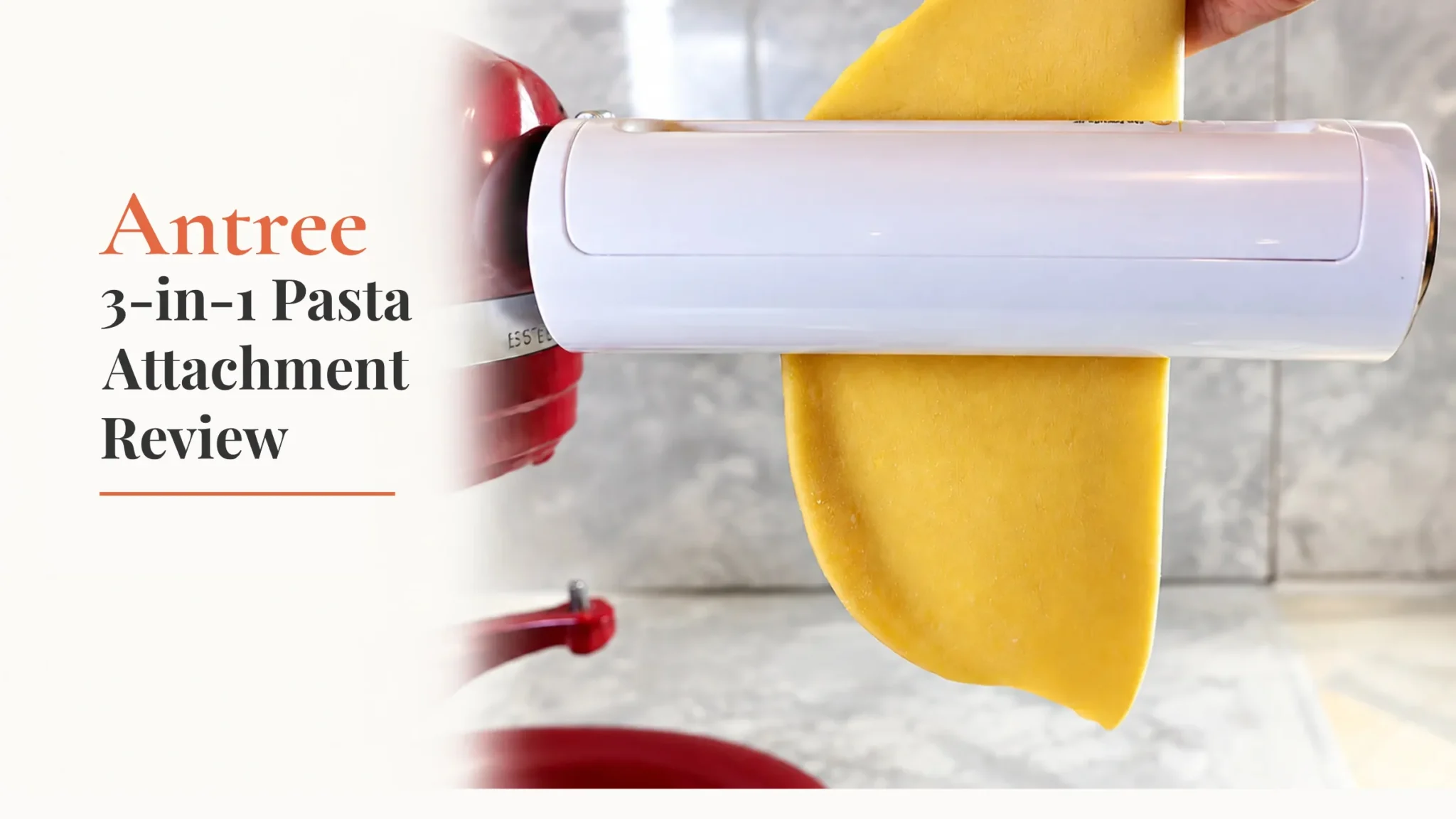 Antree 3-in-1 pasta maker attachment rolling a golden sheet of fresh pasta on a red KitchenAid stand mixer.